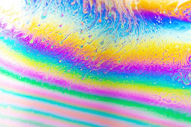 Vivid abstract close-up of a colorful soap bubble showing swirling patterns