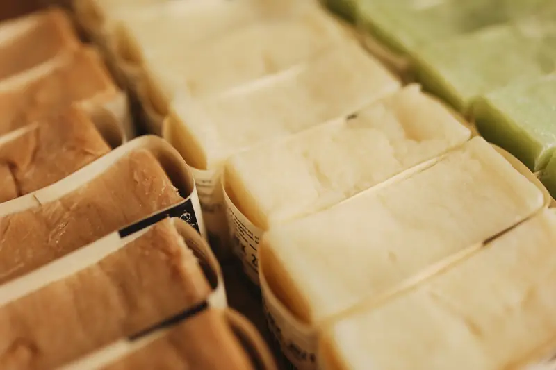 A variety of handmade natural bar soaps displayed in an organized manner, perfect for skincare and eco-friendly beauty products
