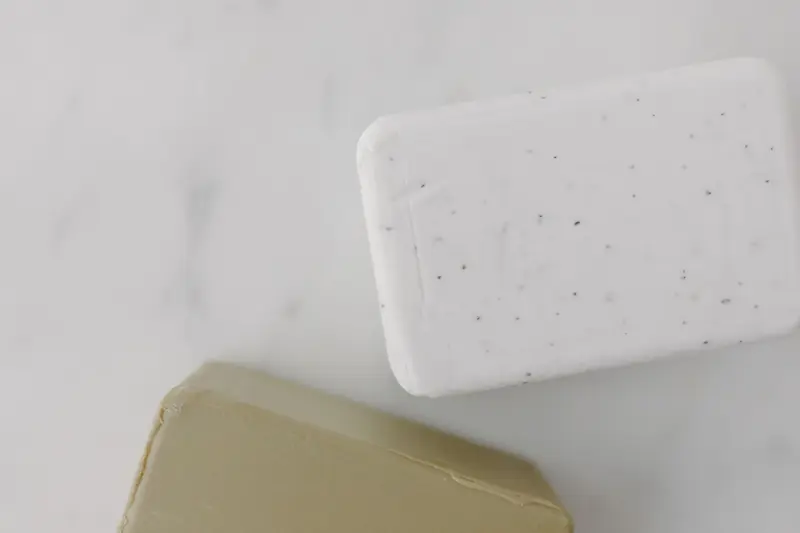 Elegant overhead shot of two soap bars on marble, perfect for skincare and hygiene themes