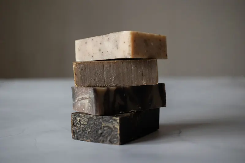 Stack of aromatic natural handmade soaps placed on gray table against blurred background