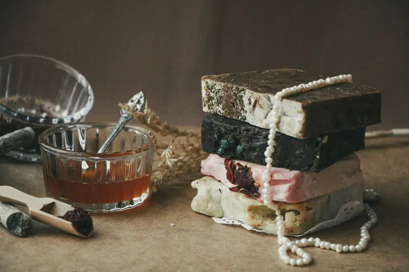 A stack of rustic handmade soap bars with natural ingredients and honey in a cozy setting