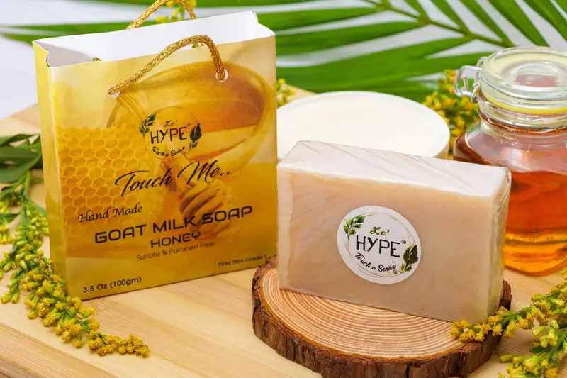 Elegant display of handmade goat milk soap with honey, surrounded by natural elements for an organic appeal