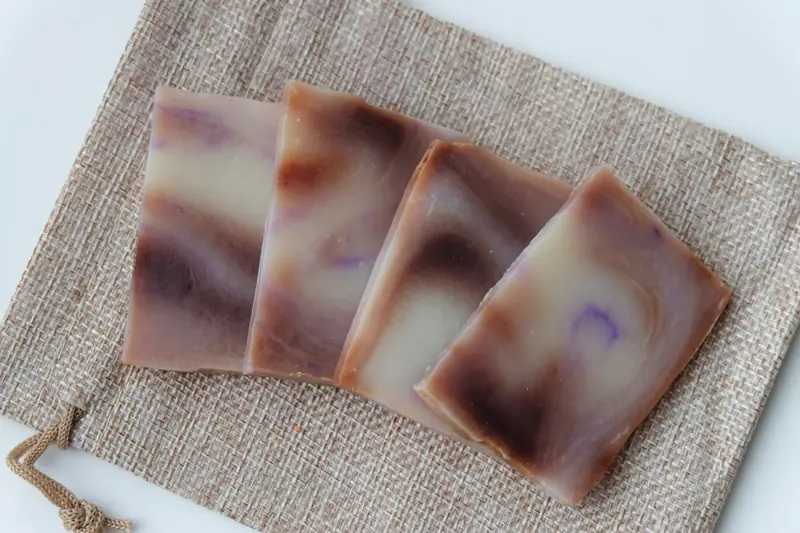 Aesthetic arrangement of handmade soap bars with swirled design on a burlap mat