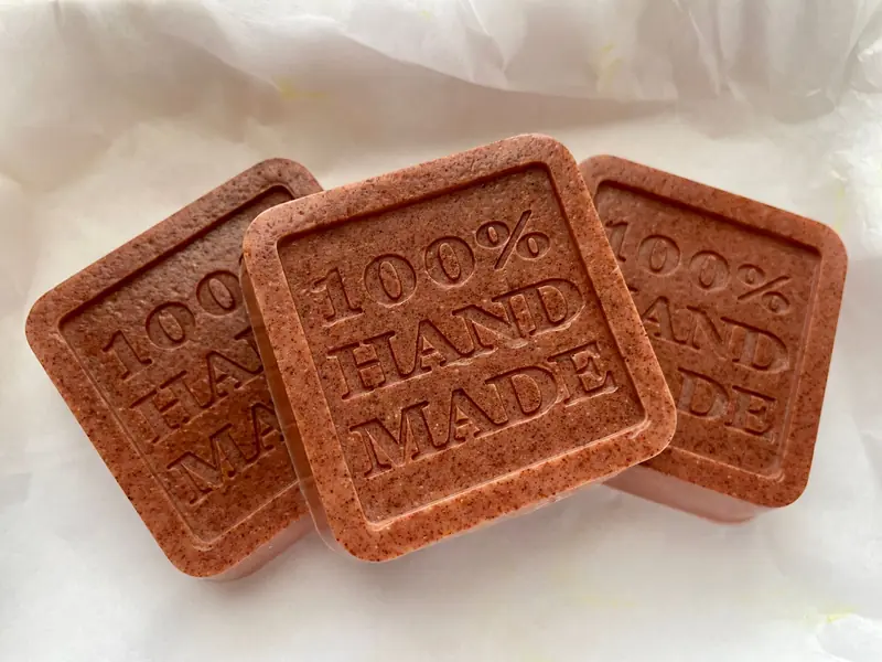 Close-up of natural, 100% handmade organic soap bars on white paper